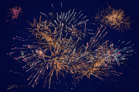 Fireworks over a dark sky, many colorful explosions.の写真素材