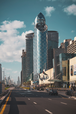 DUBAI, UAE - JAN 1, 2019: Road outside the Burjuman Metro station with Burj Khalifa and the city center visible in the distance. Morning shotのeditorial素材