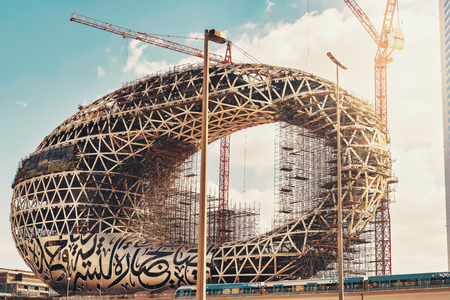DUBAI, UAE - JAN 20, 2019: The construction of the Museum of the Future one of the world's most advanced buildings. Metro passing by. Opening 2019のeditorial素材