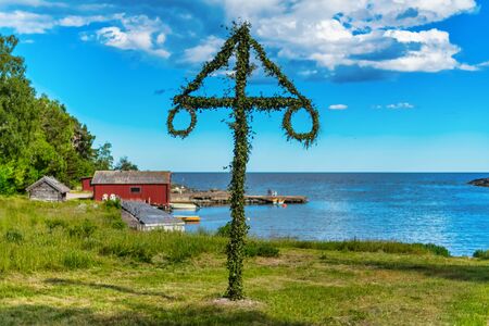 Classic midsommer pole at the coast line of Roslagen, Swedenの写真素材