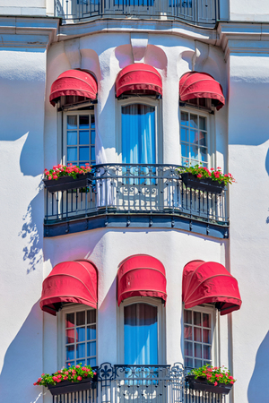 STOCKHOLM, SWEDEN 29 JUNE, 2019. Red colorful blinders at the white ornamented hotel Diplomat with french balconys facing StrandvÃ¤gen in Stockholm during summer.のeditorial素材