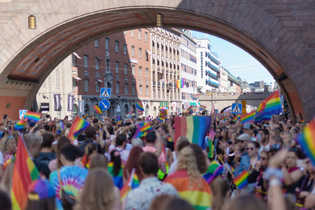 STOCKHOLM, SWEDEN - AUG 3, 2019: Crowded streets of Stockholm with waving rainbow flags during the pride parade.のeditorial素材
