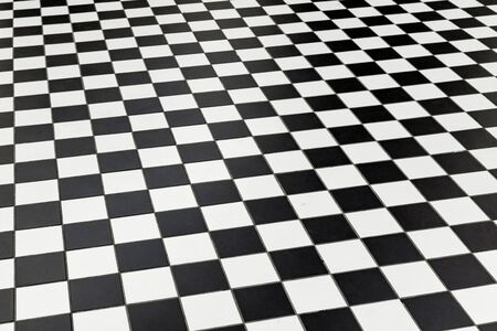 Checkered black and white floor tiles at a public station in perspective. Shottenring Ubahn, Vienna, Austriaの写真素材