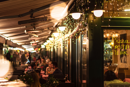 VIENNA, AUSTRIA, OCTOBER 24, 2019: Vienna Nachmarkt during a autumn evening, many small resturants serving food from different cultures in one place.のeditorial素材