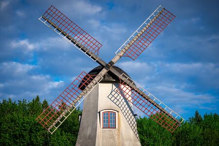 Windmil with forest and blue cloudy summer sky. Swedenの写真素材