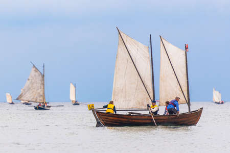 GRISSLEHAMN, SWEDEN - JUNE 18, 2022: Vintage rowingboats with sail in the traditional Postrodden between Grisslehamn and Eckero.のeditorial素材
