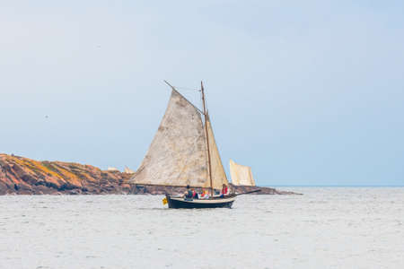 GRISSLEHAMN, SWEDEN - JUNE 18, 2022: Vintage rowingboats with sail in the traditional Postrodden between Grisslehamn and Eckero.のeditorial素材