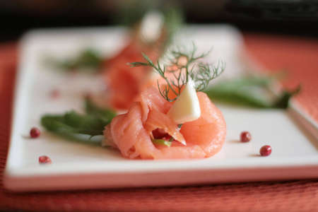 Smoked salmon rolls with butter, rocket and wild fennelの写真素材