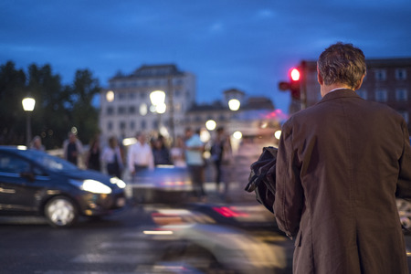 businessman crossing the road in the lights of the nightの写真素材