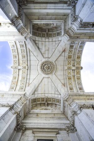 view from below of the Rua Augusta arch in Lisbon on a sunny day