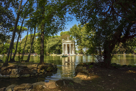 Garden of Villa Borghese. Lake with boats and temple of Esculapio.Rome Italyのeditorial素材