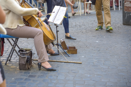 street artist plays the cello in the streets of Romeの写真素材