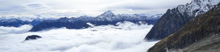 Monte Bianco, Italy. Aerial view of the Alps surrounded by clouds.の写真素材
