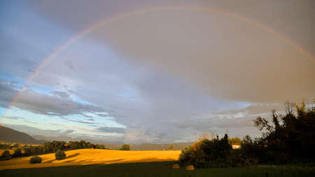 rainbow at sunset in the countryside in Italyの写真素材