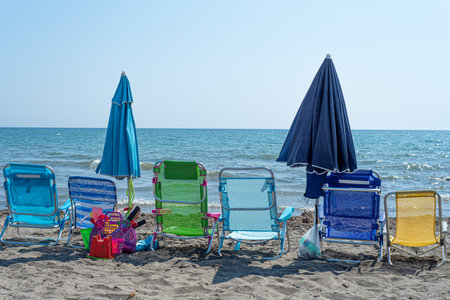 Colorful deck chairs on the beach by the sea. Summer and holidays conceptの写真素材