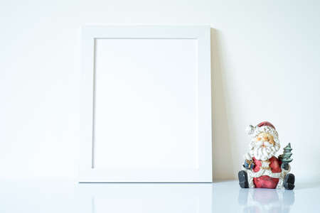 Vertical white blank frame mockup with funny Santa Claus decor. Kids greeting card mockupの写真素材