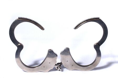 Modern open Handcuffs isolated over white backgroundの写真素材