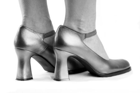 Woman's feet in silvery shoesの写真素材