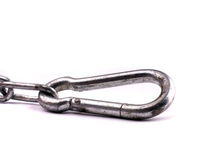 Carabiner on silvery metal chain isolated over white backgroundの写真素材