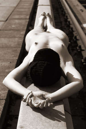 Lovely nude woman enjoying the sun at the harbour.の写真素材
