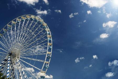 Bavarian Ferris Wheel agains blue sky with white clouds.の写真素材