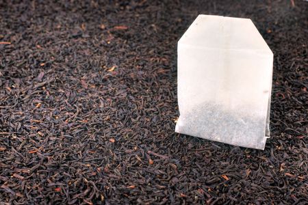 Tea bag and dried tea leaves. Macro still life with shallow dof.の写真素材