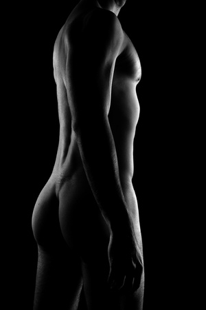 Young muscular sporty man over black backgroundの写真素材