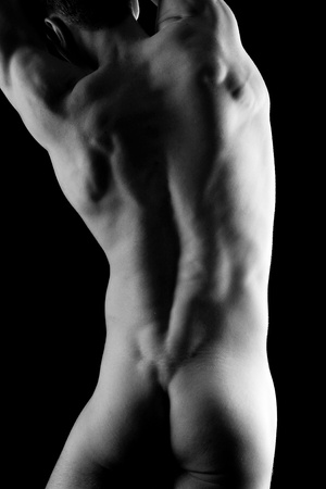 Young muscular nude man with hat over black backgroundの写真素材