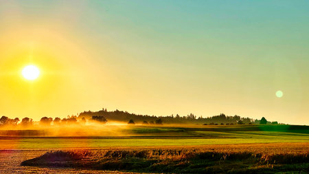 Sunset over the field with fog in the morning. Landscape.の写真素材
