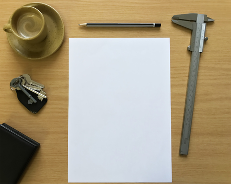 A coffee, vernier and blank page to start the day.の写真素材