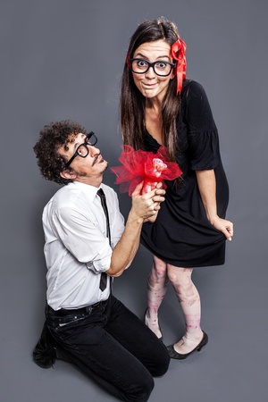 nerd gives a gift to his nerd girlの写真素材