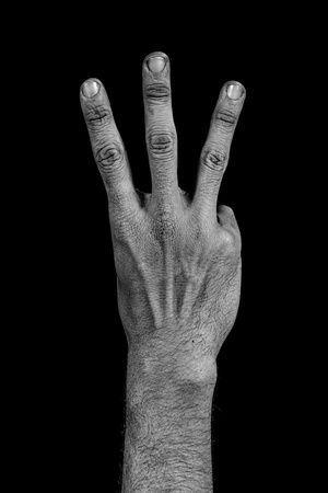 number three composed by a grunge hand isolated on black backgroundの写真素材