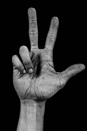number three composed by a grunge hand isolated on black backgroundの写真素材