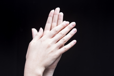 Female hands, isolated on black background, are clappingの写真素材