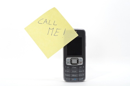 yellow memo with call me message on a mobile phoneの写真素材