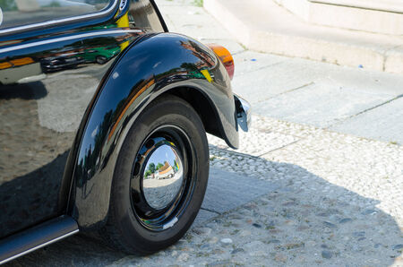 Old car wheel in a show in italyの写真素材