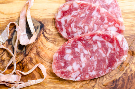 Sliced salami on a wood boardの写真素材