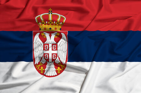 Serbia flag on a silk drape wavingの写真素材