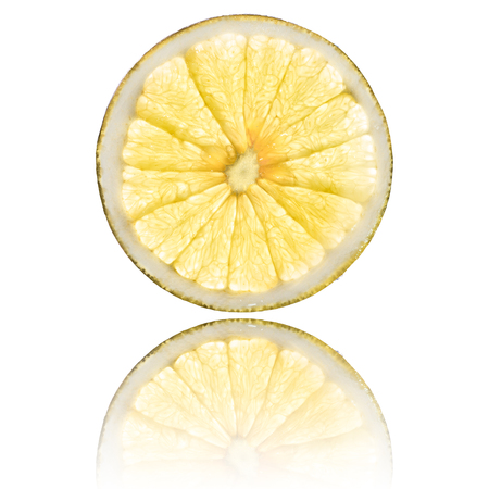 grapefruit slice isolated on white background back lighted and reflectionの写真素材