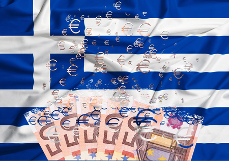 euro banknote dissolving as a concept of economic crisis in greeceの写真素材