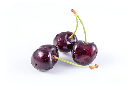 bunch of fresh dark red cherries isolatedの写真素材