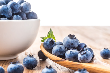 fresh blueberry on a wooden table and bowlの写真素材
