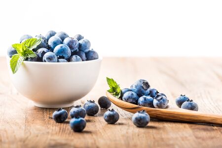 fresh blueberry on a wooden table and bowlの写真素材