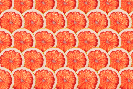 perfect rows of ripe pink grapefruit slicesの写真素材