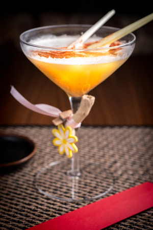 strong alcoholic cocktail in a sushi restaurant on a dark deskの写真素材