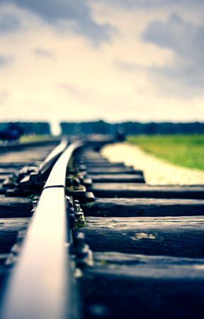 close up of an old rail with stormy clouds duo tonedの写真素材