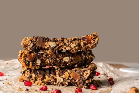 healthy homemade muesli bar with cereal, chocolate and pomegranate and copyspaceの写真素材