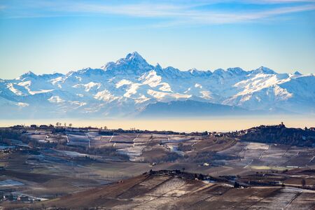 Mount Viso and Vineyard hills under snow in Langhe region in Italyの写真素材