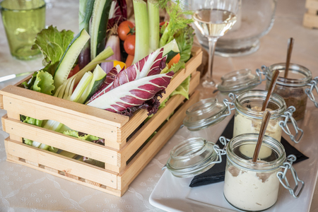 wooden box of organic vegetables in a restaurantの写真素材