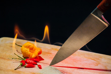 burning hot chillies on a flaming chopping board